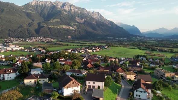 Aerial View of Liechtenstein with Houses on Green Fields in Alps Mountain Valley