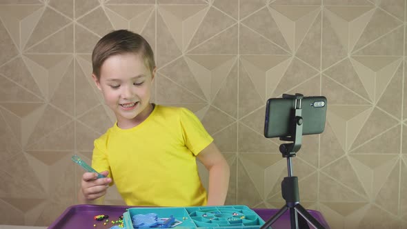 Positive Boy Blogger Is Recording Videos on a Mobile Phone