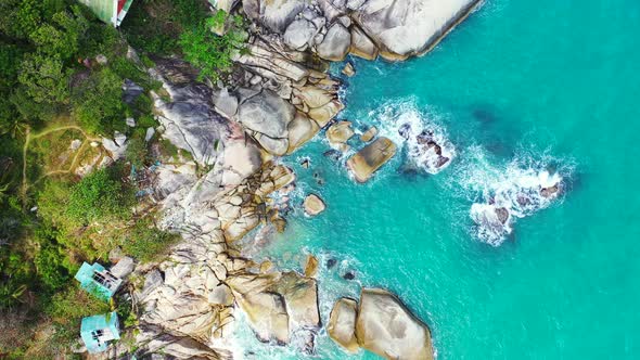 Beautiful rocky Thailand coast with bungalows and houses on the edge of elevated coast. turquoise se