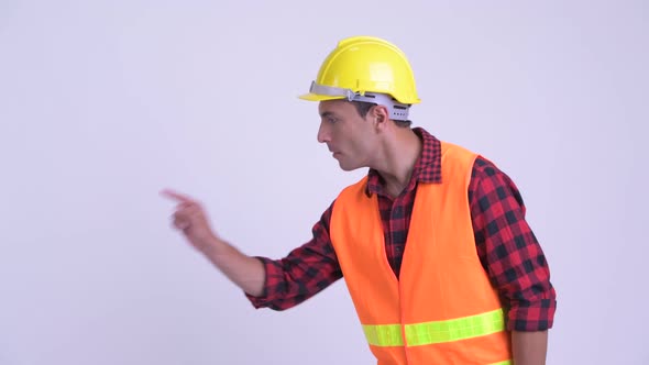 Young Happy Hispanic Man Construction Worker Touching Something and Giving Thumbs Up