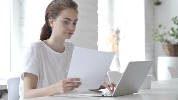 Pensive Young Woman Working in Office Paperwork