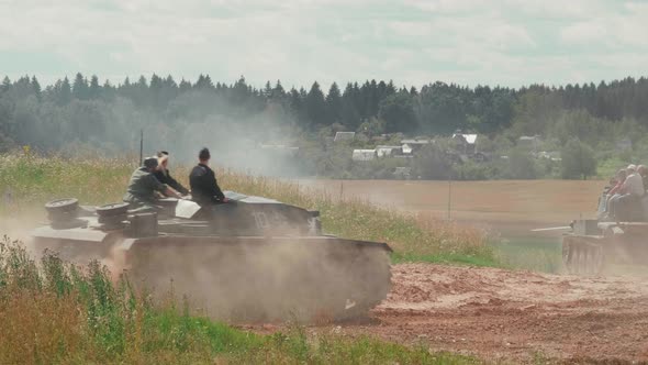 Tanks Drive Along the Sandy Road To the Battlefield