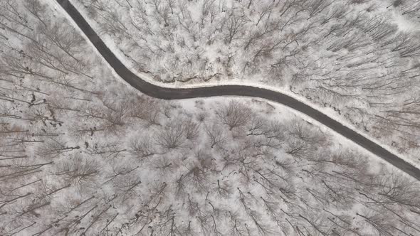 Winding road and snowy landscape 4K aerial video