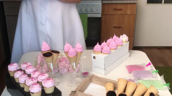 A Woman Makes Waffle Cones With Marshmallows. Decorated With Sprinkles And Mastic Snowflakes.