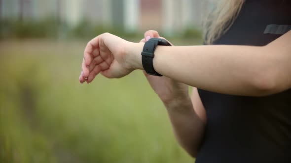 Girl Use Smart Watch.Runner Checking Pulse On Smartwatch On Running Workout.Athlete Using Smart Band