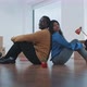 Young multi ethnic couple sitting on the floor of their new home - VideoHive Item for Sale