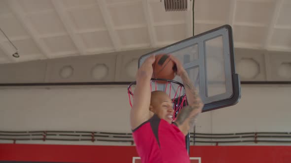 Basketball Player Making Reverse Dunk in Game