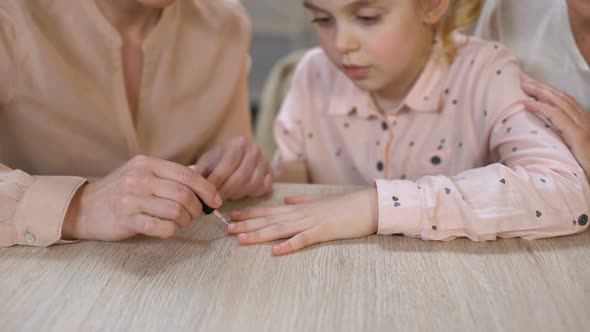 Young Mother Doing Manicure for Daughter, Spending Time Together, Female Leisure