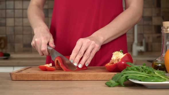 Woman in the Kitchen Cuts Red Paprika Pepper Slow Motion
