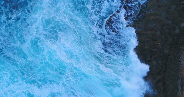 Aerial zenith view between rocks and waves in the Caribbean sea