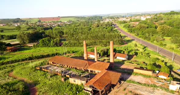 Chimney of a ceramic factory at sunny day. Aerial view orbit