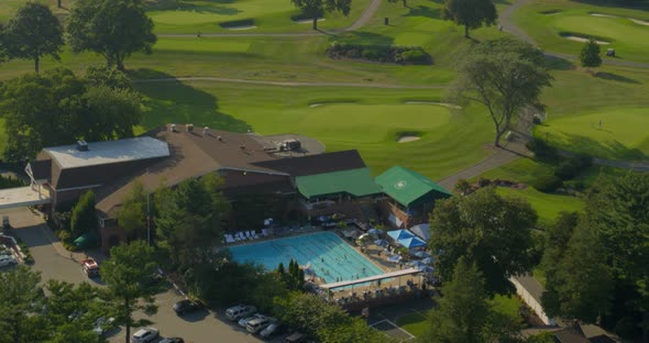 Rising Shot from an Outdoor Pool to Aerial View of a Golf Course in Long Island