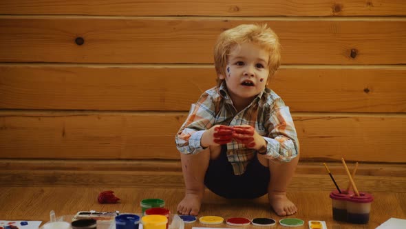 Happy Child Colors His Hands. Kids Finger Painting. Art Therapy for Children. Psychology of the