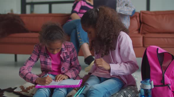 Creative Children Drawing in Notebook at Home