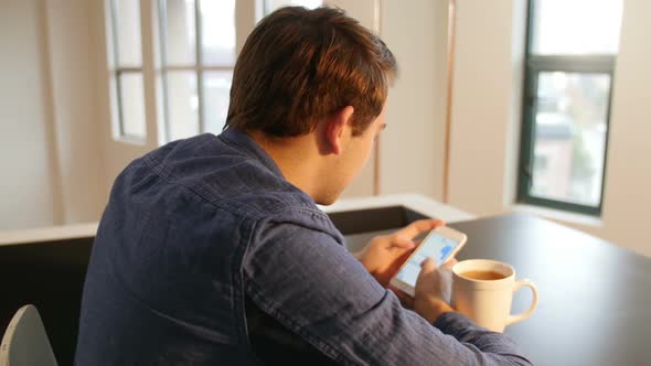 Man using mobile phone with black coffee on table