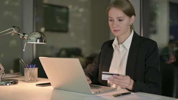 Successful Businesswoman Adding Credit Card in Office Computer at Night