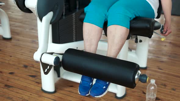 Close Up Female Legs on Weight Lifting Machine.