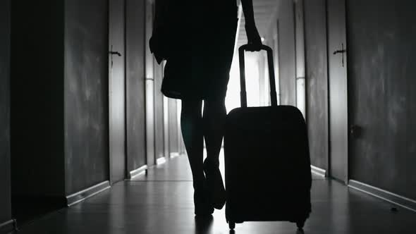 Silhouette of Woman Walking towards Hotel Room