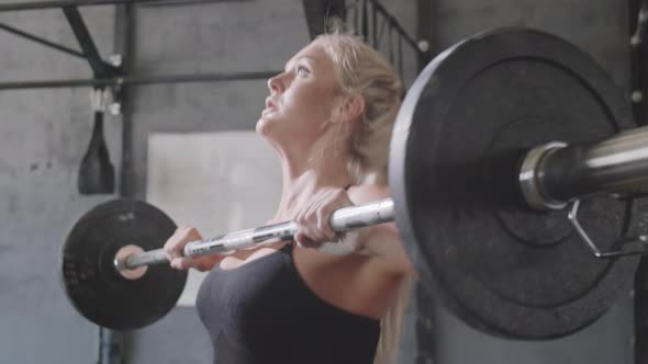 Female Athlete Performing Barbell Overhead Squats alt