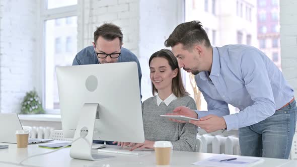 Focused Startup Team Working Together on Desktop and Tablet