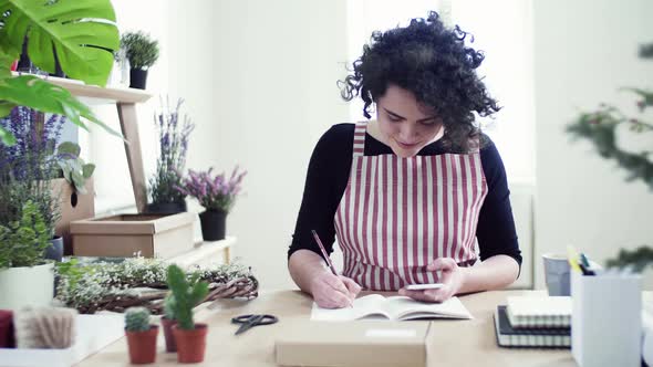 Young florist checking incoming mail orders