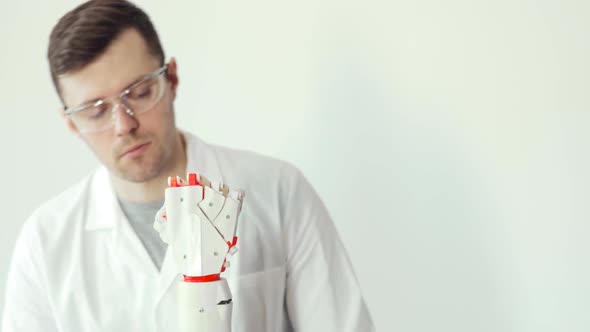 Engineer Scientist Is Testing Robotic Prosthesis Hand Which Makes Movements with Fingers