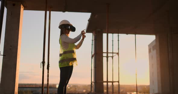 Female Engineer Wearing VR Headset Managing Construction Project