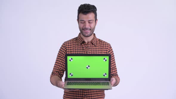 Happy Bearded Persian Hipster Man Showing Laptop