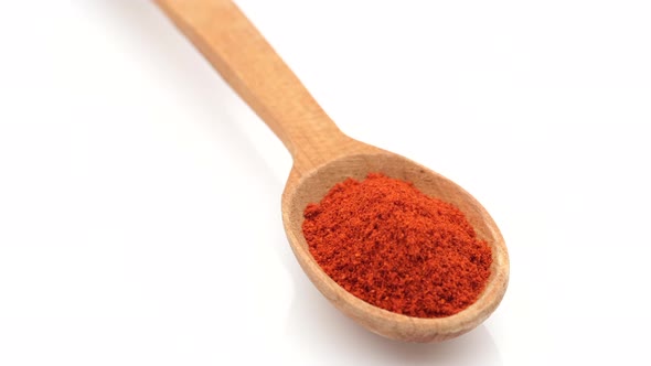 seasoning sweet smoked paprika in wooden spoon rotating 