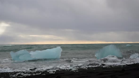 Waves Crashing Over Blue Icebergs.