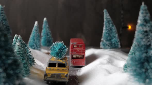 Winter Forest Miniature with a Small Yellow Toy Car with a Christmas Tree on the Roof, Double-decker