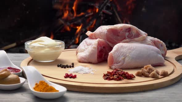 Ingredients for a Preparation of Grilled Chicken Legs on the Background of Fire