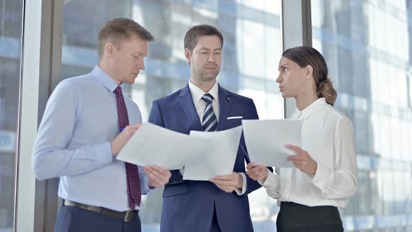 Executive Business People Doing Conversation on Documents in Boardroom