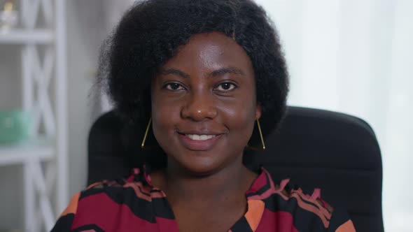 Headshot Portrait of Beautiful African American Young Woman Posing in Slow Motion in Office Indoors