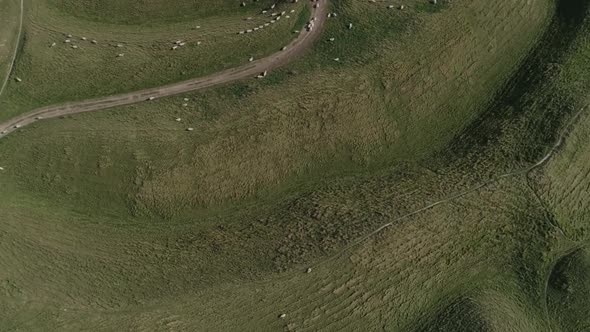 Wide top down aerial of the main western gate ramparts at Maiden Castle, near Dorchester in Dorset.