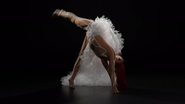 Side View of Flexible Slim Woman in Stage Costume Doing Back Walkover Standing Up Looking at Camera