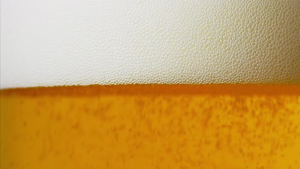 Beer bubbles forming foam beautifully in closeup