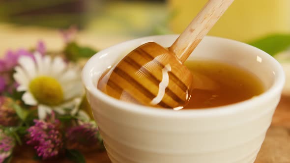 Mixing Sweet Honey Using Wooden Spoonspindle in White Bowl Closeup