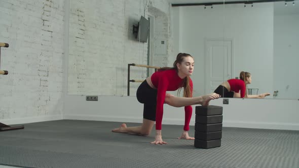 Sporty Fit Woman Doing Splits with Yoga Blocks