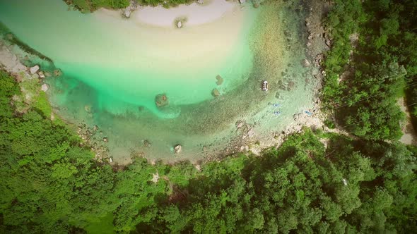 Aerial view of people doing rafting surrounded by nature at Soca river, Slovenia