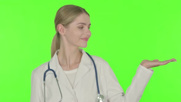 Female Doctor Showing on Side on White Background