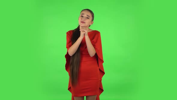 Pretty Young Woman Is Keeping Palm Together and Asking for Something. Green Screen
