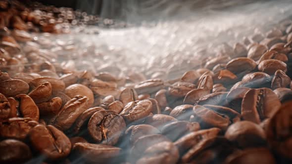 Close Up of Seeds of Coffee. Fragrant Coffee Beans Are Roasted Smoke Comes From Coffee Beans