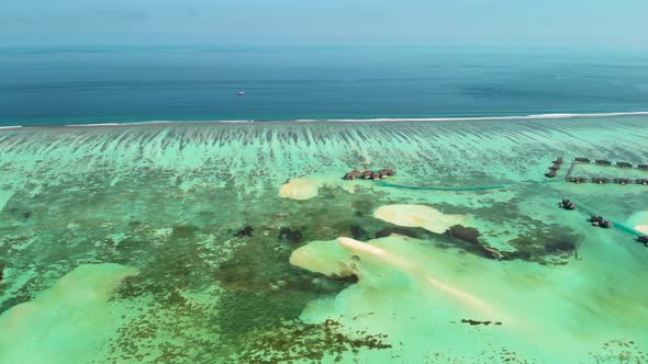 Turquoise Lagoon with Coral Reef and Water Villa