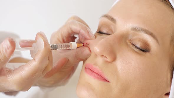 Professional Beautician Hands Inject Salon Patient Cheek