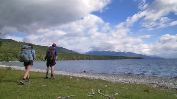 Static, Hikers stare out over Lake Te Anau, start of Kepler Track, New Zealand