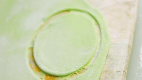 The Chef Forms Round Dough From the Green Dough with a Transparent Bowl