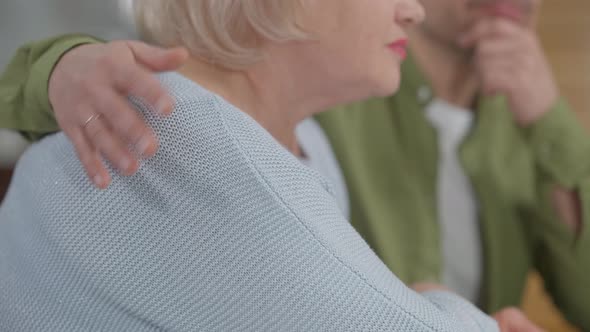 Side View Unrecognizable Senior Woman with Young Man Hugging Stroking Shoulder