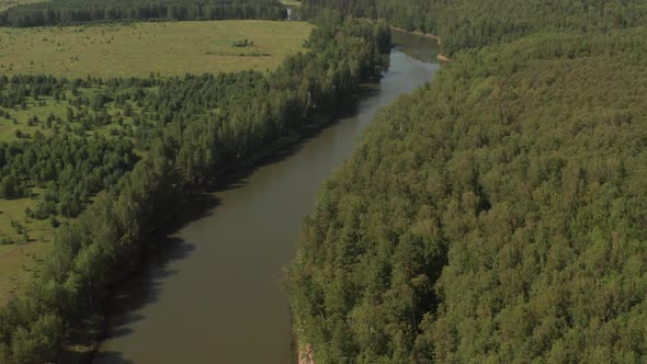 River and Forest, Shot From a Quadcopter, Top View of a Thin River and Fields Around It