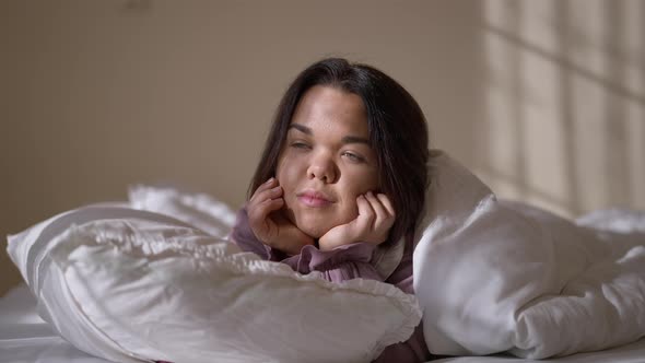 Young Little Woman Looking Away Dreaming and Looking at Camera Smiling